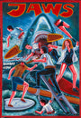 A hand-painted Deadly Prey movie poster in oil and enamel on flour sack shows a giant shark attacking panicked swimmers amid blood and chaos. "JAWS" is boldly at the top, with BOMBAY VIDEO on the left.