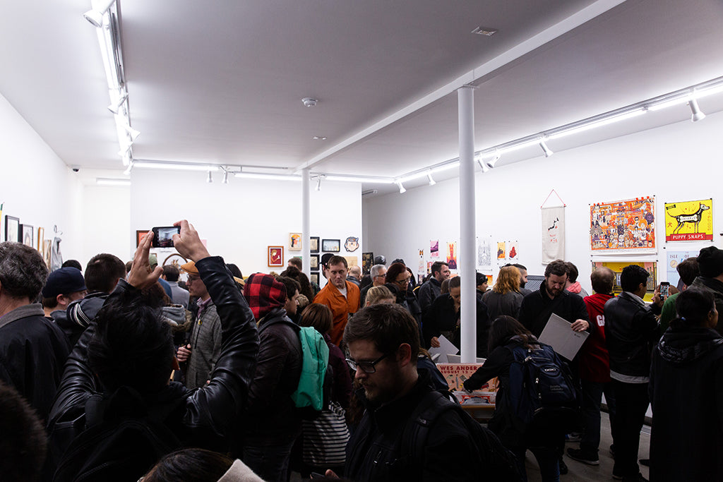 Photograph of a crowed art gallery.