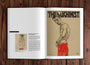 A Paragon Books magazine lies open on a wooden table, displaying a striking movie poster for The Machinist with an illustration of a muscular man in red pants; the opposite page features a smaller artwork image and text about the artist, reminiscent of fine art book entries.