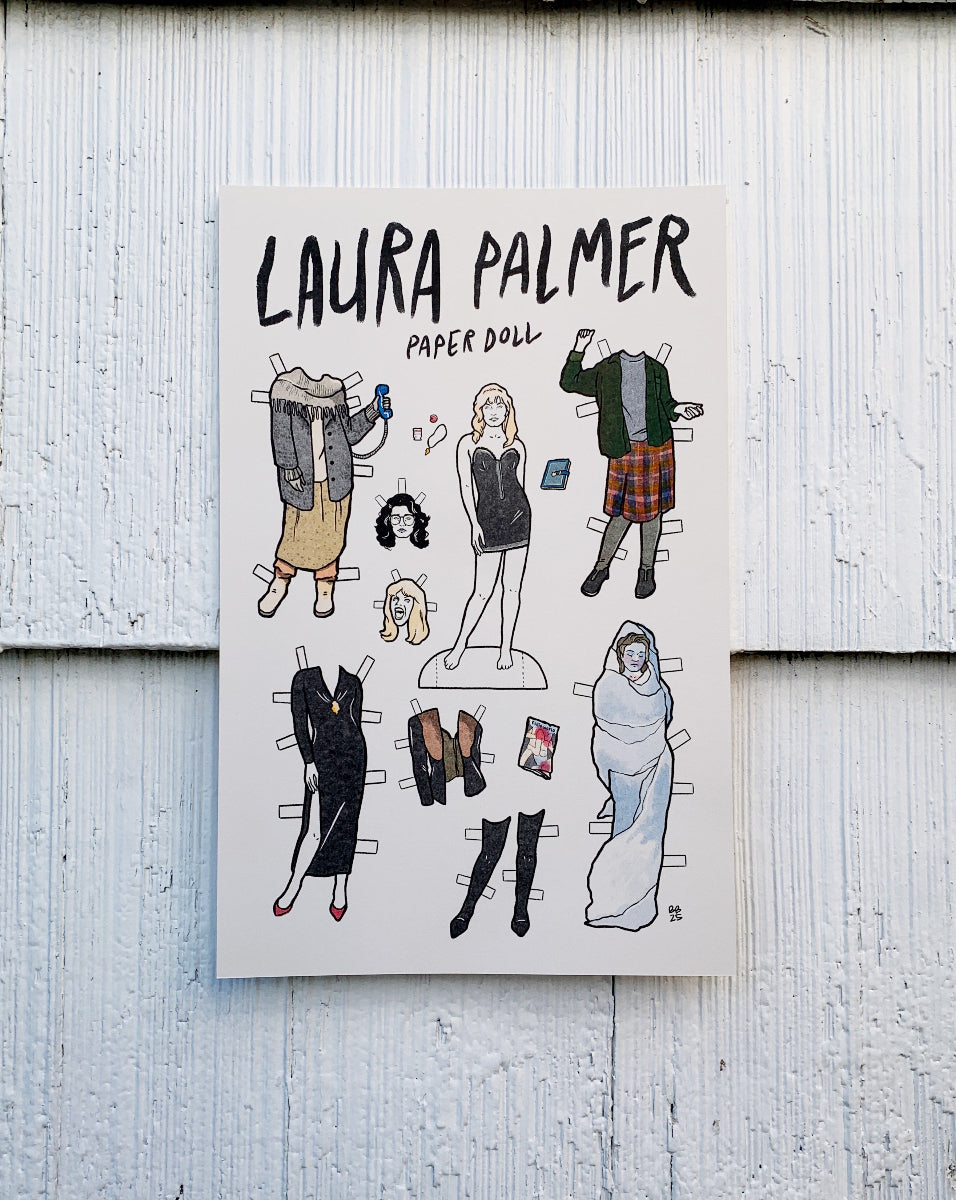 Laura Palmer paper doll set on a wooden surface