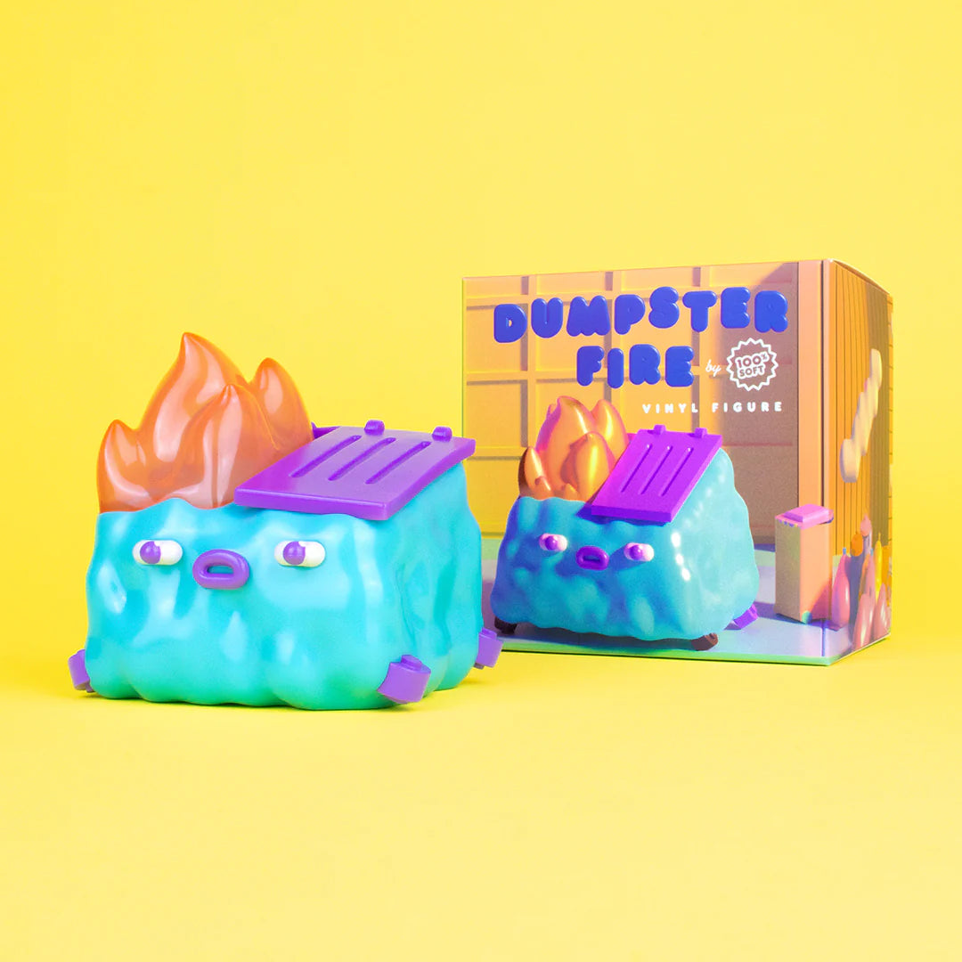 A limited edition 100% Soft Dumpster Fire vinyl figure features a blue dumpster with a purple lid, orange flames, and a cartoon face, displayed beside its colorful box labeled Dumpster Fire on a bright yellow background.