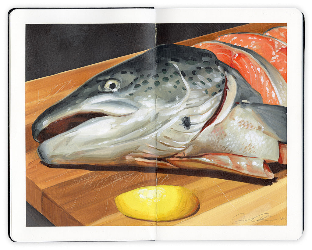 open faced Moleskine notebook with a still life painting of a chopped salmon head on a wooden cutting board, with a lemon wedge beside it by artist David Rice