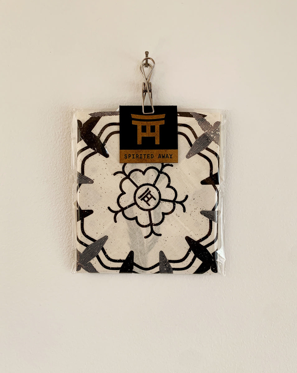 Packaged product with black and white design and a visible brand logo on a beige background