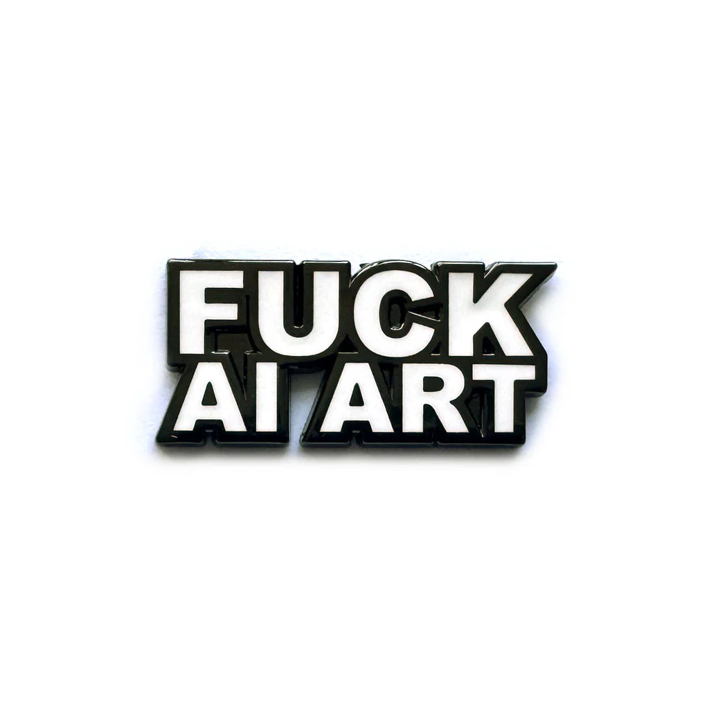 A black and white hard enamel lapel pin by Spoke Art featuring bold, all-caps text that reads FUCK AI ART.