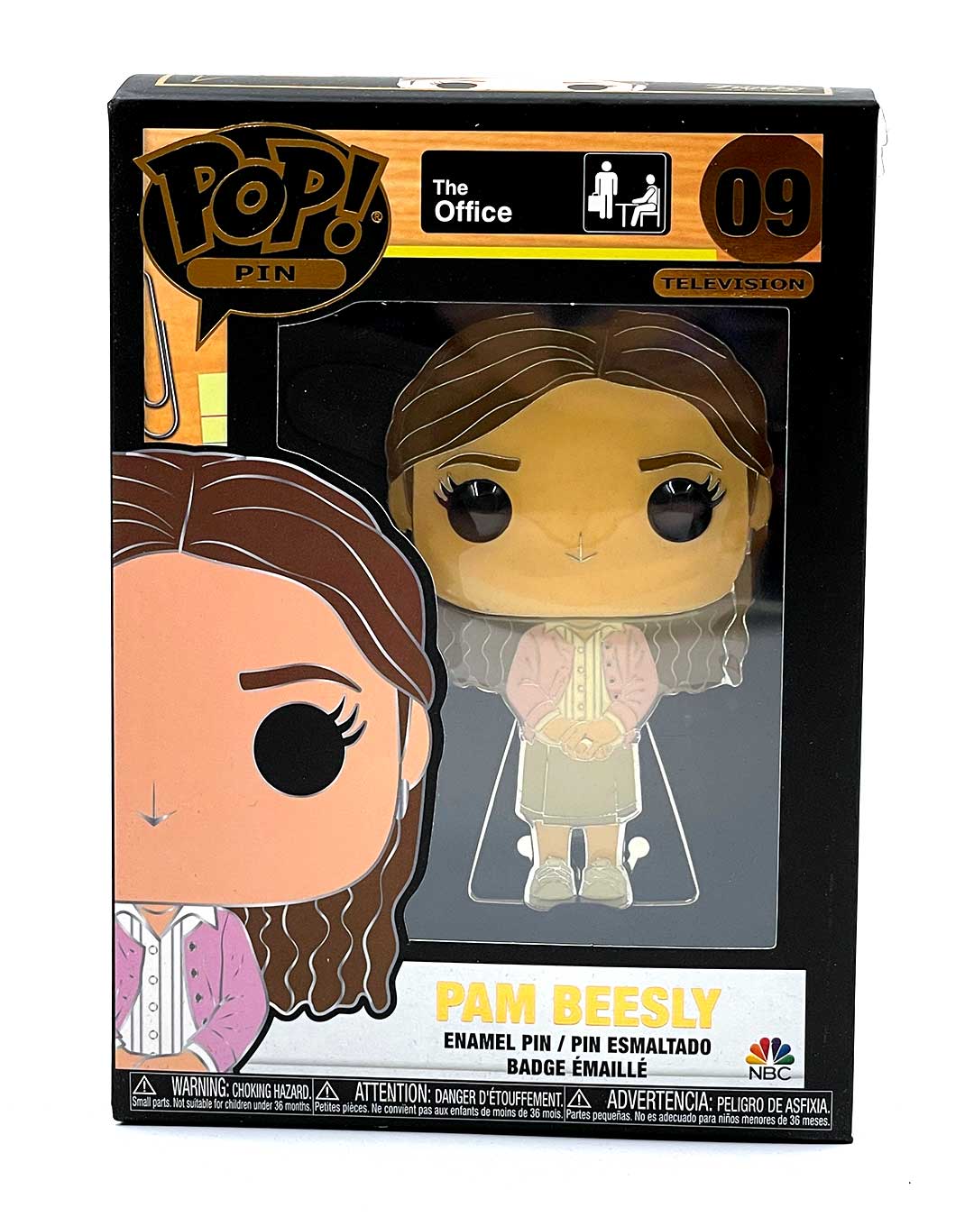 A FUNKO Pop! Pin of Pam Beesly from The Office is displayed in its black box packaging, labeled as number 09. This collectible enamel pin features Pam Beesly wearing a pink cardigan and skirt, with The Office series logo and FUNKO Pop branding clearly visible.