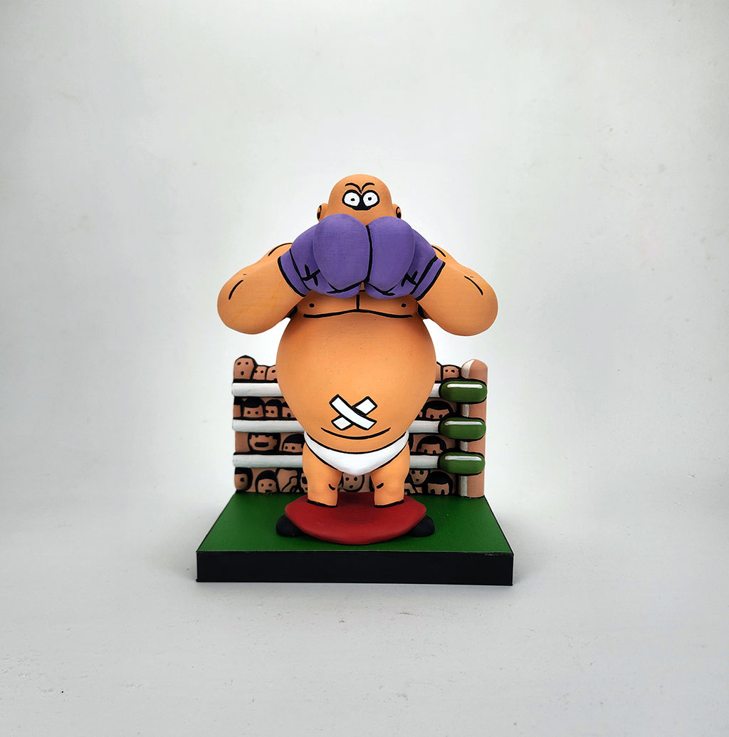A cartoon-style King Hippo figurine by Geoff Trapp, inspired by Mike Tyson's Punchout, features purple gloves and a bandaged stomach on a platform, set before a cheering crowd and boxing ring in a dynamic video game scene.