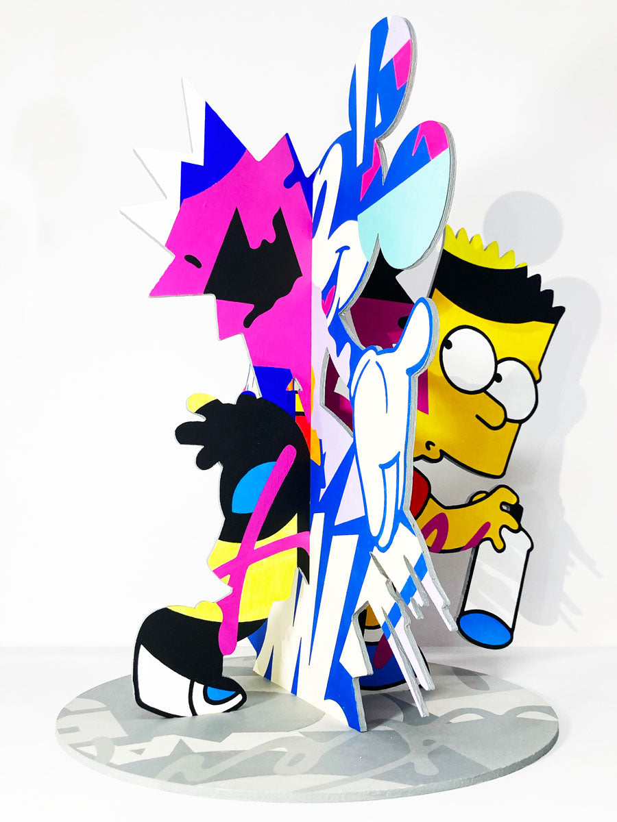 A vibrant abstract sculpture by Greg Gossel for Spoke Art features cartoon-inspired figures, including a Bart Simpson-like character with a spray can, all hand-painted in acrylic on a round base for the 15th Anniversary Show.