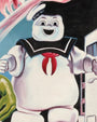 A cheerful cartoon marshmallow mascot with a sailor hat reading "STAY PUFT," inspired by the Ghostbusters character, stands by a building in this vibrant Deadly Prey digital print.