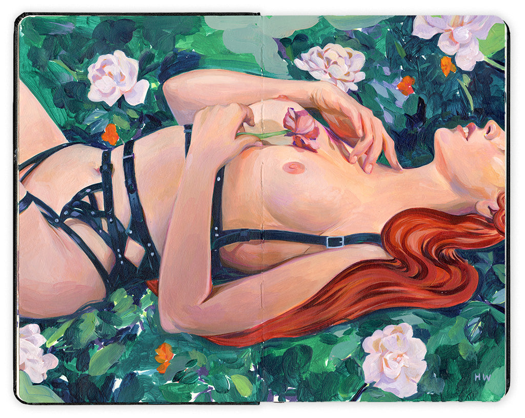 painting in an open face Moleskine notebook of a nude woman with red hair wearing strappy harnesses and holding a flower against her chest as she lays in a lush garden by artist Helice Wen