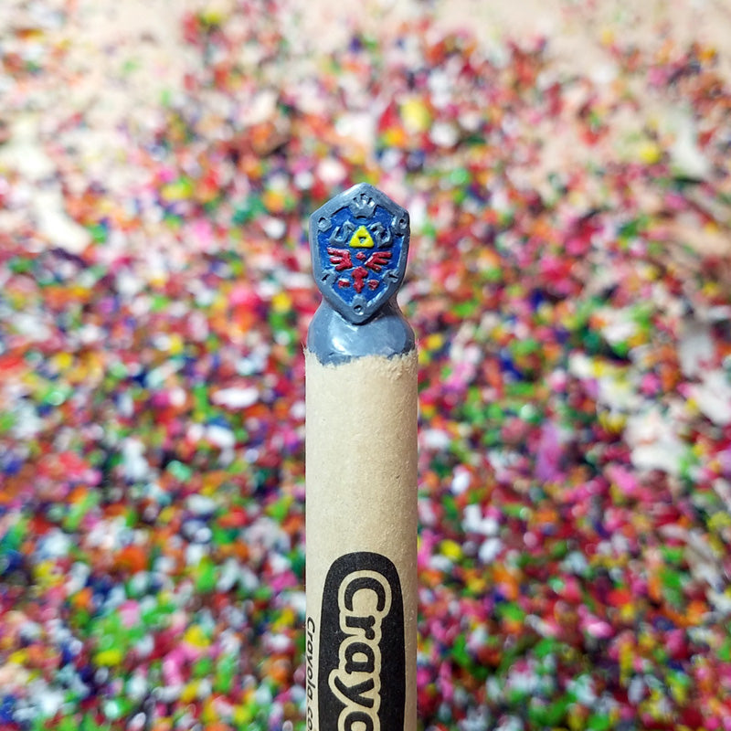 Crayola crayon with a shield from Legend of Zelda against a colorful background