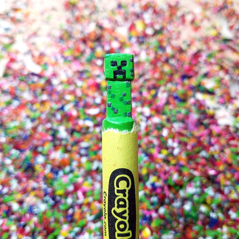 Crayola crayon with a Minecraft Creeper eraser against a colorful background