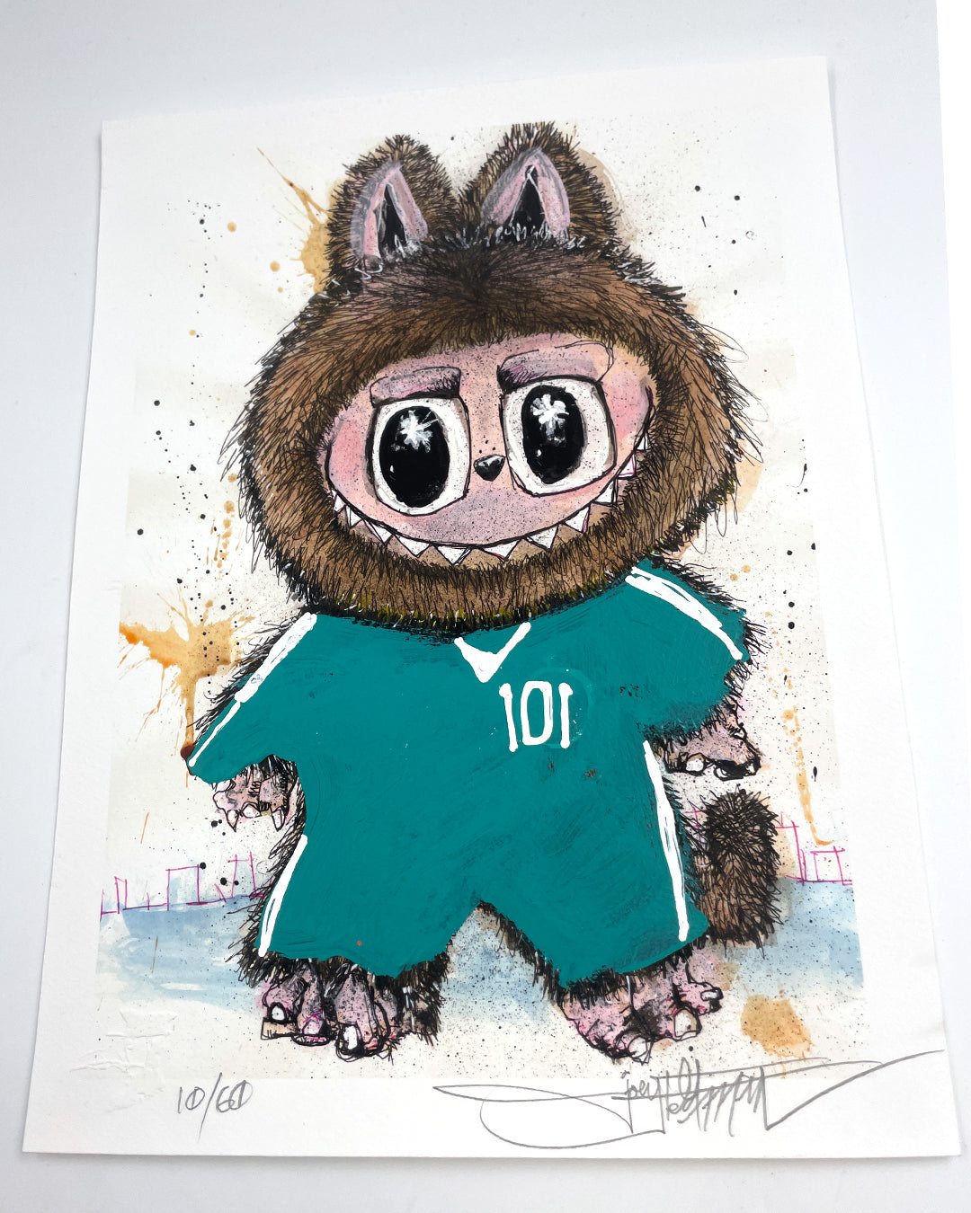 A whimsical creature with big eyes, fluffy fur, and cat-like ears wears a teal 101 jersey. Abstract splashes pop on the white background in this signed and numbered Joey Feldman archival pigment print.