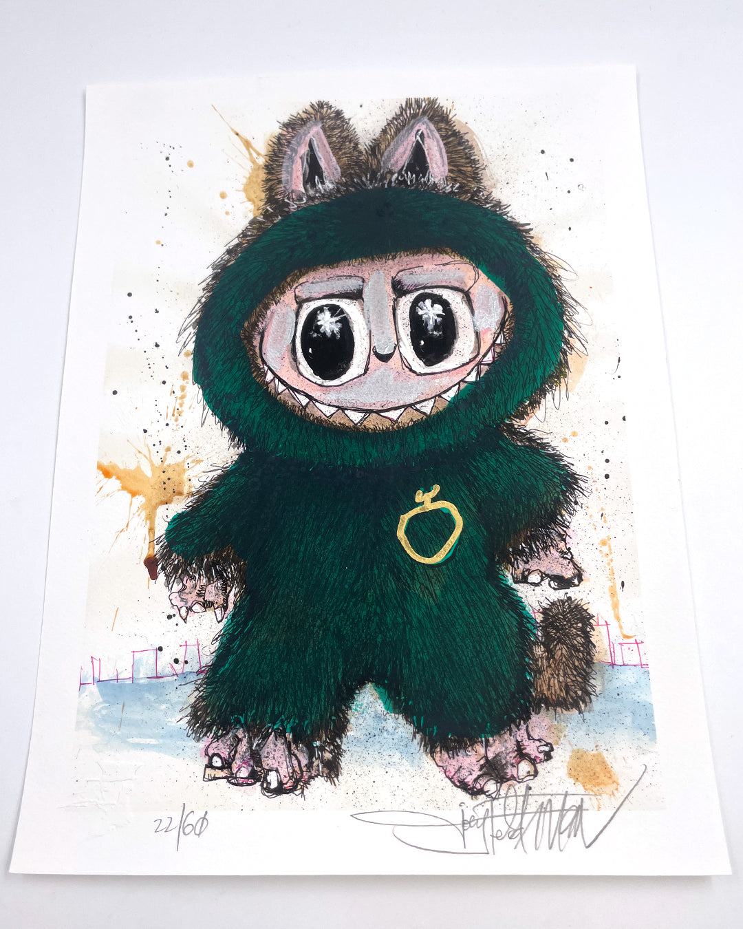 A whimsical Joey Feldman archival pigment print shows a wide-eyed character in a furry green costume with pink ears, claws, and tail on a light background. It features a gold ring and is signed at the bottom.