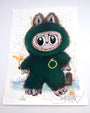 A wide-eyed cartoon creature in a fuzzy green suit holds a gold ring amid abstract splatters. This Joey Feldman artwork is hand-signed at the bottom and features unique hand-painted embellishments.