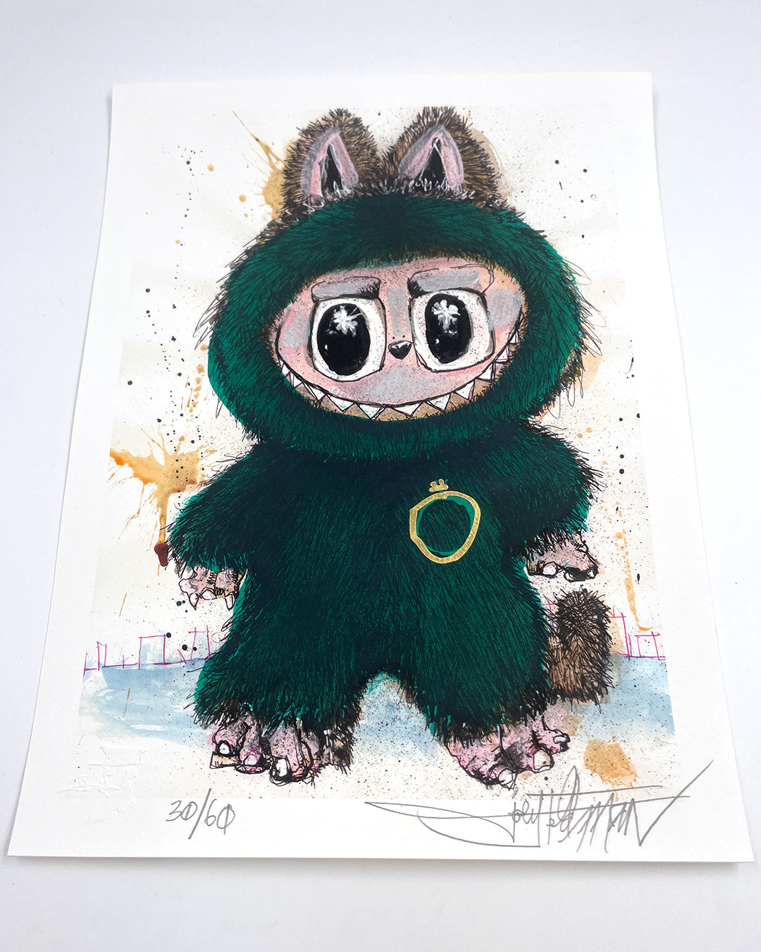 A Joey Feldman archival pigment print of a cute, wide-eyed cartoon creature in a fuzzy green costume with pointy ears and tail, hand-embellished with colorful splashes on a white background.