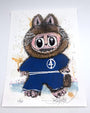 A whimsical Joey Feldman illustration features a fuzzy, wide-eyed, raccoon-like creature in a blue Fantastic Four uniform, standing upright amid colorful splatters and vivid archival pigment print details.