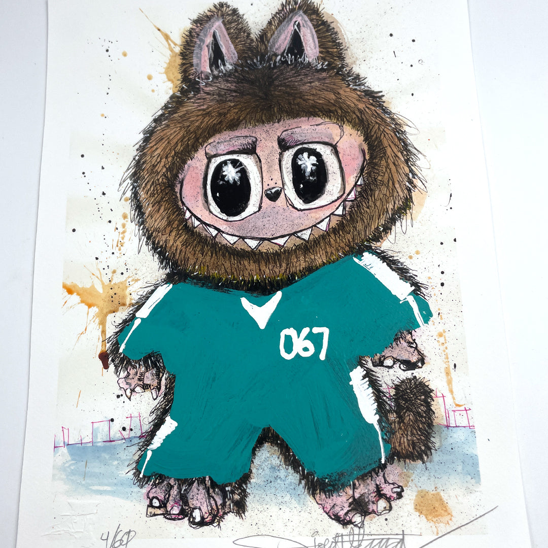 A whimsical archival pigment print by Joey Feldman depicts a furry creature in a teal outfit numbered 067, with large eyes, sharp teeth, and animal-like traits. Each print is signed and numbered in the corners.