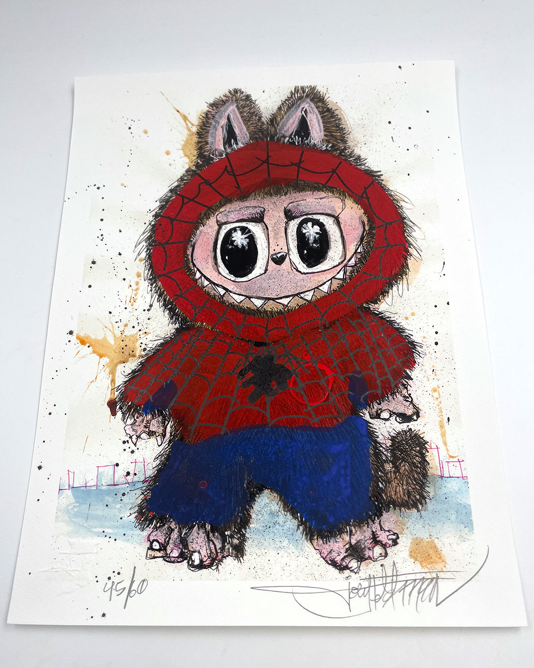 A whimsical Joey Feldman illustration of a wide-eyed animal in a red Spider-Man-style hoodie and blue pants, set on a white background with brown and gold hand-painted details. The artwork includes the artists signature at the bottom.