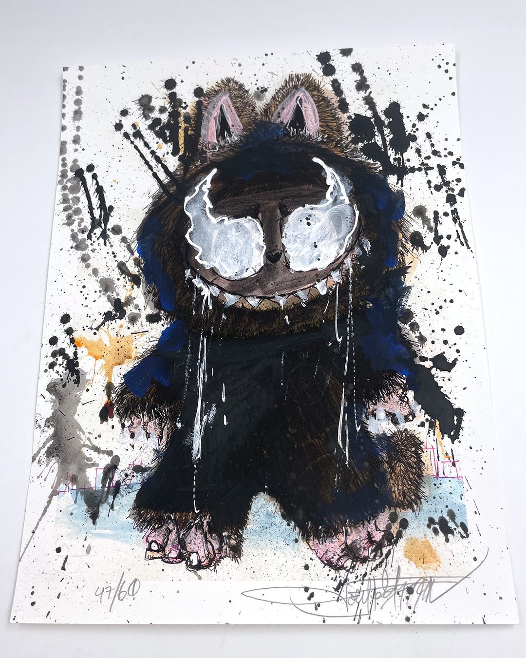 Joey Feldmans archival pigment print features a furry, monster-like creature with silver eyes and sharp teeth, standing on two legs. Black splatters and colorful abstract marks enliven the white background, with hand-painted embellishments.