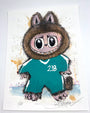 A cartoon character with big eyes, a wolf-like hood, sharp teeth, and a green tracksuit labeled 218 is set on a splattered background in this signed and numbered Joey Feldman archival pigment print.