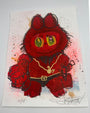 A vibrant Joey Feldman artwork showcases a fuzzy red creature with glowing green eyes, small portraits, and a heart-faced figure in a gold chain holding a lantern among red splatters and hand-painted details.