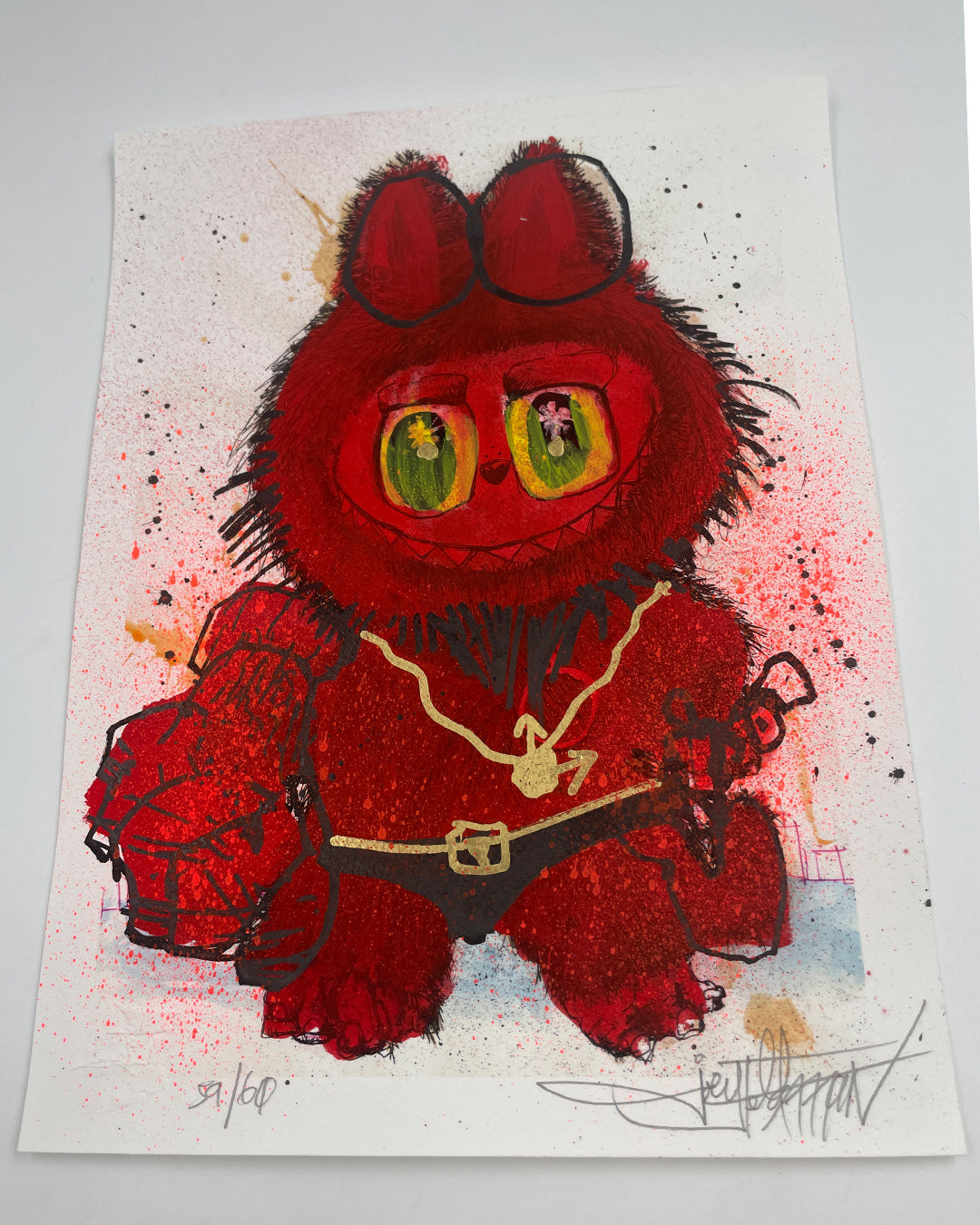 A vibrant Joey Feldman artwork showcases a fuzzy red creature with glowing green eyes, small portraits, and a heart-faced figure in a gold chain holding a lantern among red splatters and hand-painted details.