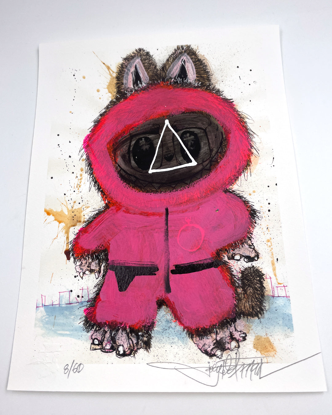 A Joey Feldman archival pigment print featuring a furry animal in a bright pink hooded suit with a triangle on its black face shield, inspired by Squid Game guards. Signed, numbered, and hand-painted embellished.