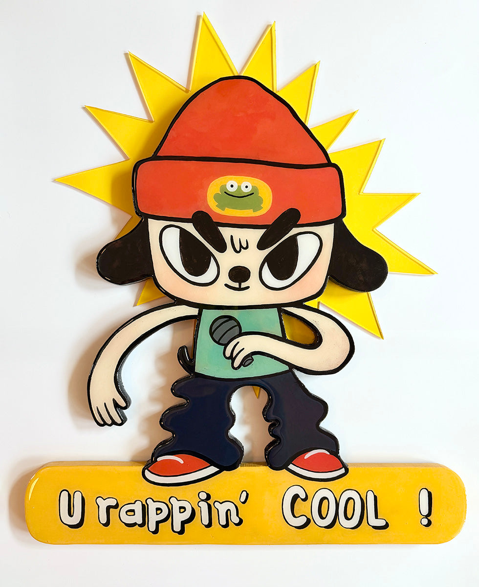 Cartoon character with a red hat and microphone, standing in front of a sun, with text 'U rappin' COOL!' below.