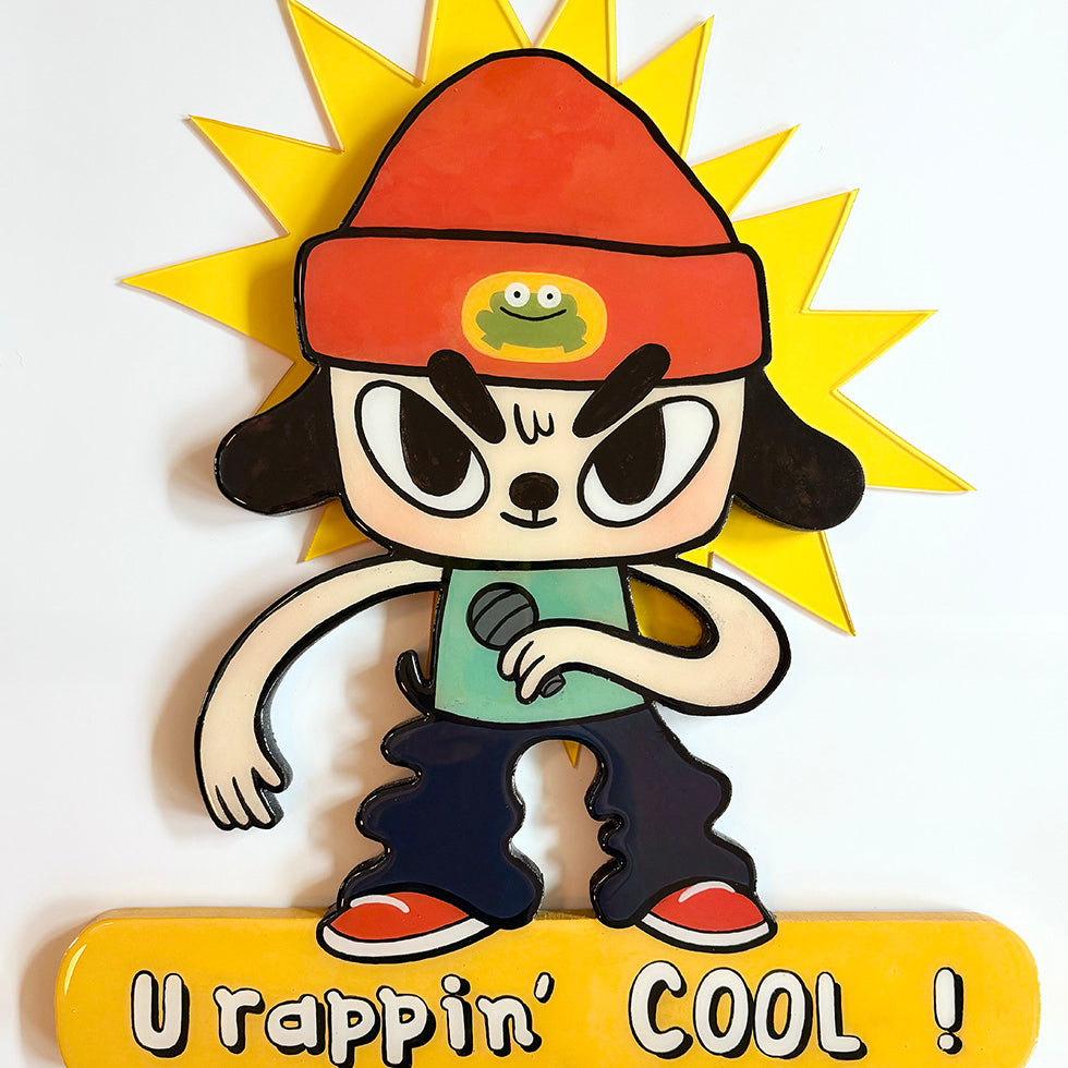 Cartoon character with a red hat and microphone, standing in front of a sun, with text 'U rappin' COOL!' below.