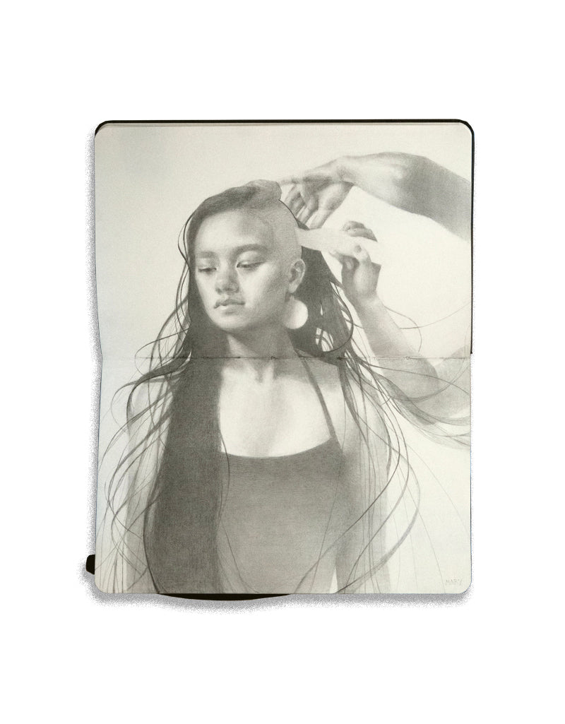 graphite drawing on an open face Moleskine notebook depicting a woman with long hair getting a buzzcut by artist Mary Lippert