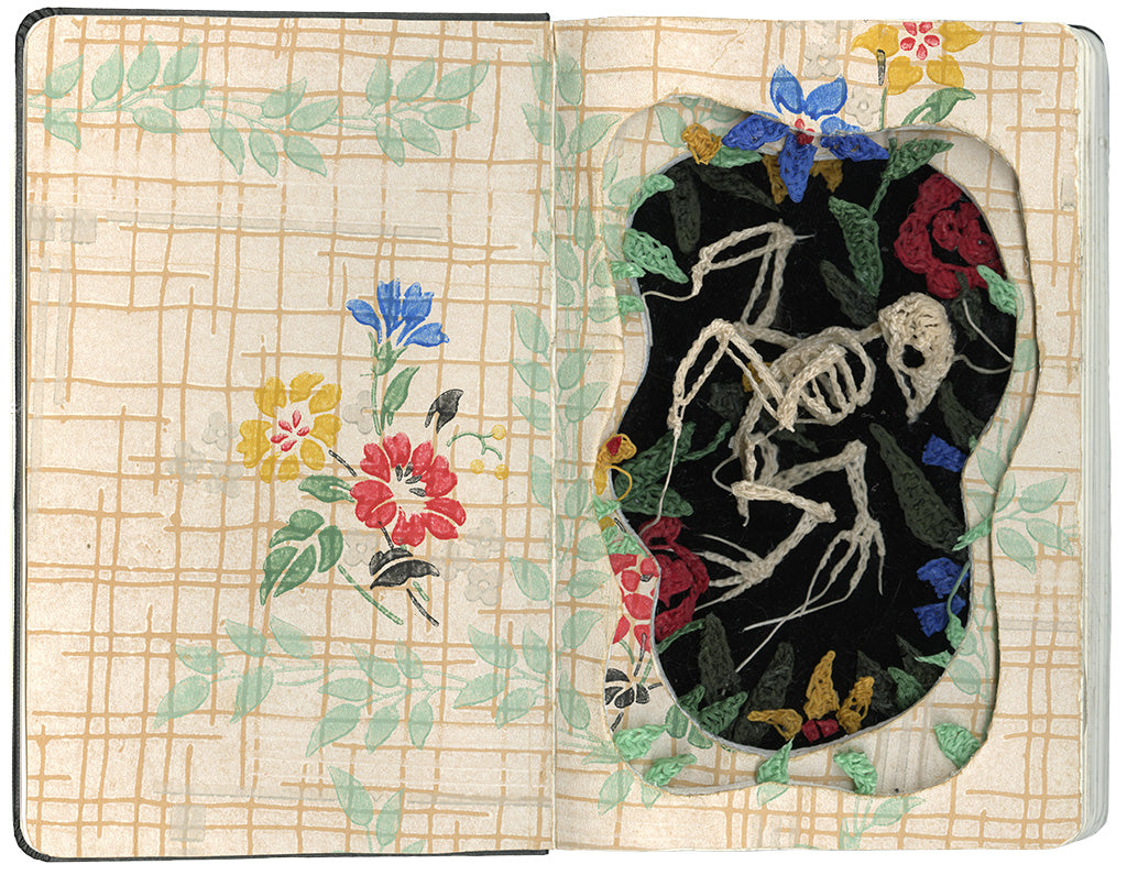 carved moleskin with a crocheted bird against a black background with floral details by artist Caitlin McCormack