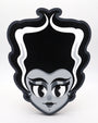 Stylized cartoon portrait of a woman with a tall, black beehive and white streaks, acrylic on wood. She has large eyes, long lashes, red lips, and a gray face on a white background. By Miles Ritchie for Spoke Art's 15th Anniversary Show.