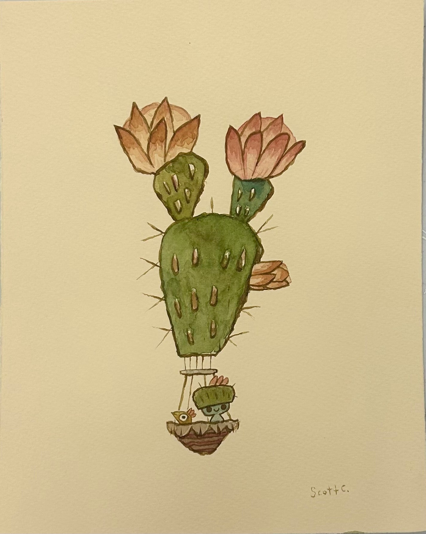 Scott C.’s “Desert Floats” is a whimsical watercolor on paper featuring a hot air balloon shaped like a cactus with pink flowers, carrying two cartoon characters in the basket. The artist’s signature appears at the bottom right.