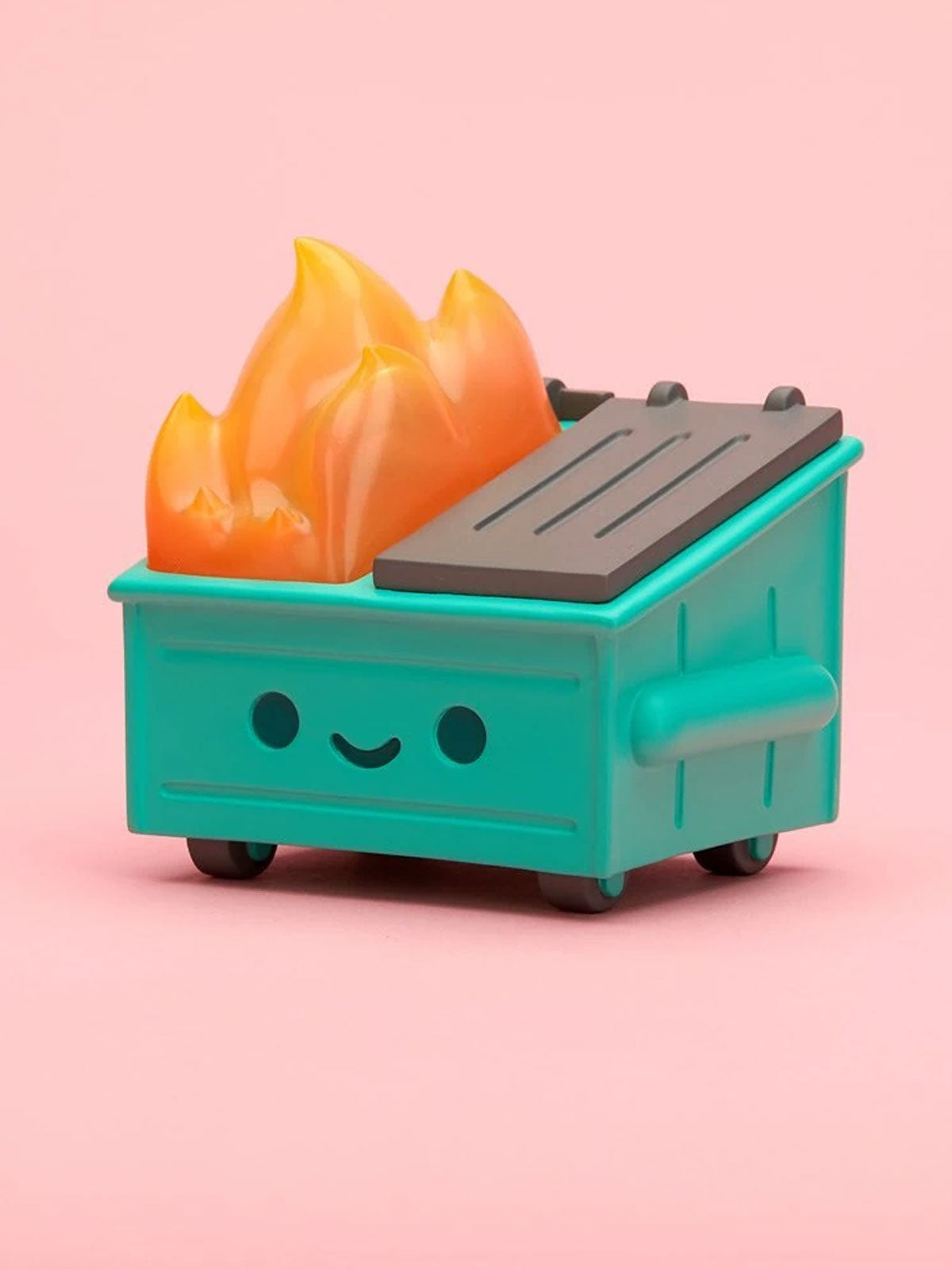 Teal toy dumpster with a flame on a pink background
