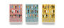 Three boxed sets of Max Dalton Wes Anderson playing cards—Volumes One, Two, and Three—each custom designed with illustrated characters on distinctive pink, blue, and yellow backgrounds that capture the unique charm of Wes Anderson’s world.