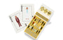 Two illustrated playing cards marked “Joker” depict people in suits. An open box labeled "Max Dalton Wes Anderson Playing Cards Volume Three" displays more custom-designed playing cards by Max Dalton, featuring illustrated characters set against a yellow background.