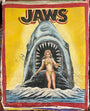 A vintage-style JAWS painting by Deadly Prey depicts a woman in a yellow bikini standing in water as a giant shark with an open mouth looms behind her; the background features bold yellow and red hues.