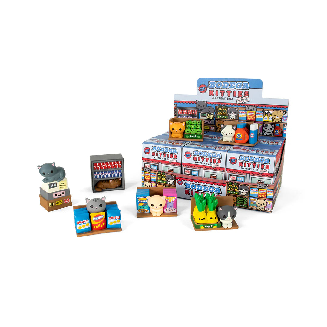 A playful 100% Soft display featuring miniature Bodega Kitties and animal figures with tiny groceries like milk cartons and cans, all arranged around colorful bodega-style boxes and shelves.