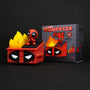 A red vinyl toy by 100% Soft shows a cartoon-faced dumpster with flames, while a small figure sits on the lid. The package displays an illustration labeled Dumpster Fire Vinyl Figure.