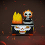 A small 100% Soft Marvel vinyl figure with a flaming skull head sits atop a black, flame-decorated vehicle featuring chains and a stylized skull face; fire and embers surround the scene, perfectly capturing the fiery chaos of a Ghost Rider Dumpster Fire.