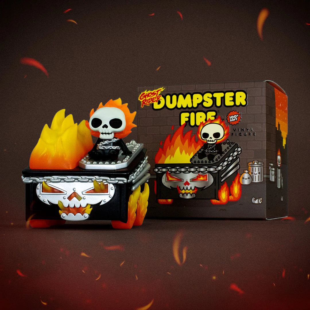 A vinyl figure by 100% Soft, inspired by Marvel’s Ghost Rider Dumpster Fire, features a skeleton with a flaming head sitting in a grinning, flaming dumpster. The box behind displays “Dumpster Fire” along with matching artwork of the fiery skeleton and dumpster.