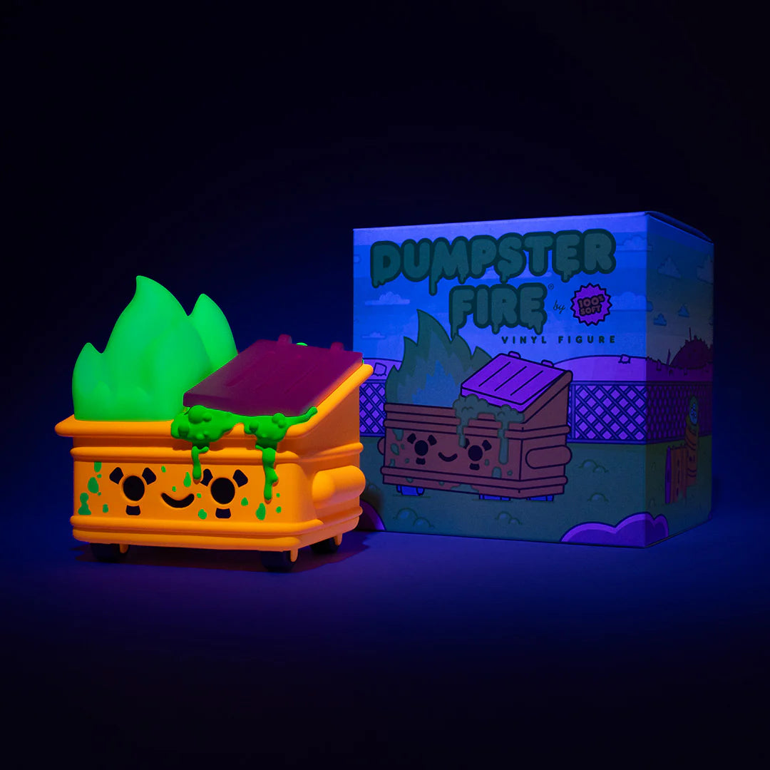 A glowing 100% Soft Dumpster Fire Vinyl Figure—smiling dumpster with green flames and slime—sits by its vibrant Discord Exclusive box, both brightly lit against a dark background.
