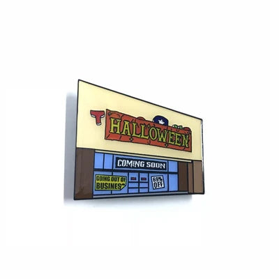 Spoke Art’s limited edition hard enamel pin features a white storefront with a Halloween sign, plus “Coming Soon” and “Going Out of Business! 60% Off” banners—playfully inspired by pop-up Halloween shops.