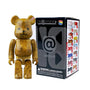 A wood-grain Bearbrick figure from Medicom's Bearbrick Series 48 stands beside its sleek black box, adorned with vibrant Bearbrick illustrations and a choking hazard warning for ages 15 and up. Produced by Medicom, this collectible offers the thrill of a blind box surprise for your collection.