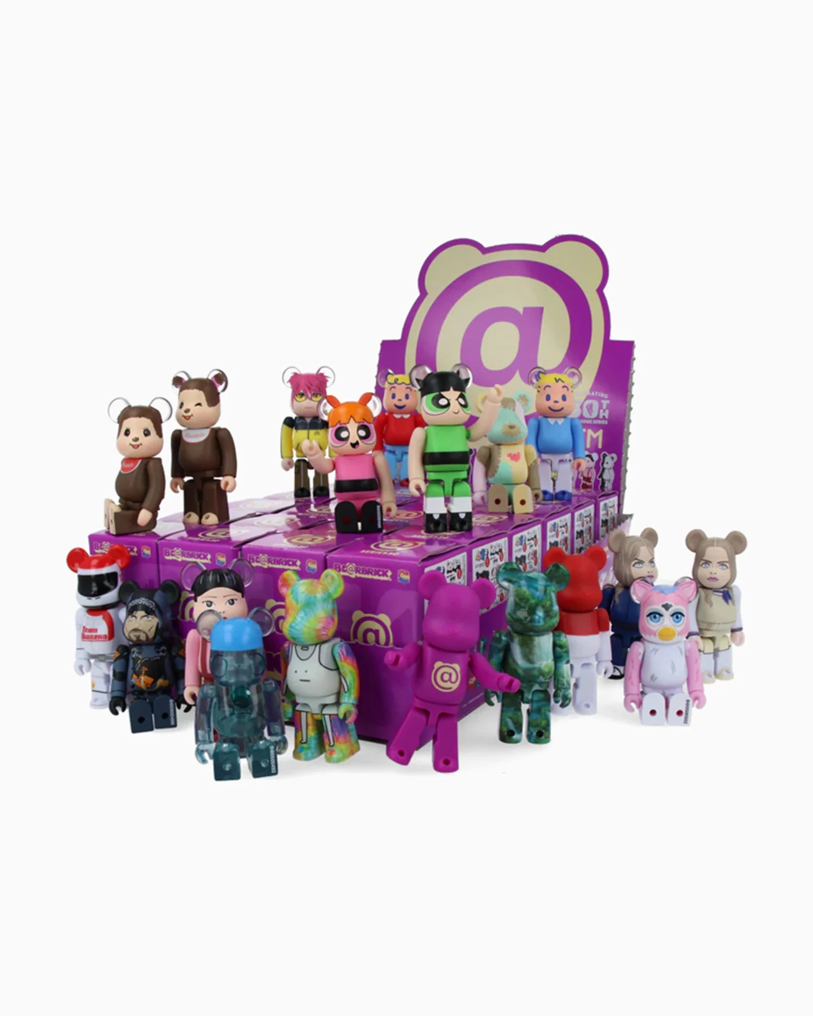 A vibrant lineup of bear-shaped collectible figures from Medicom, some styled as superheroes and animals, stands before a purple box adorned with an @ symbol and playful cartoon designs—these delightful toys are part of the Be@rbrick Series 50 collection, ideal for enthusiasts eager to discover which surprise figure awaits inside each blind box.