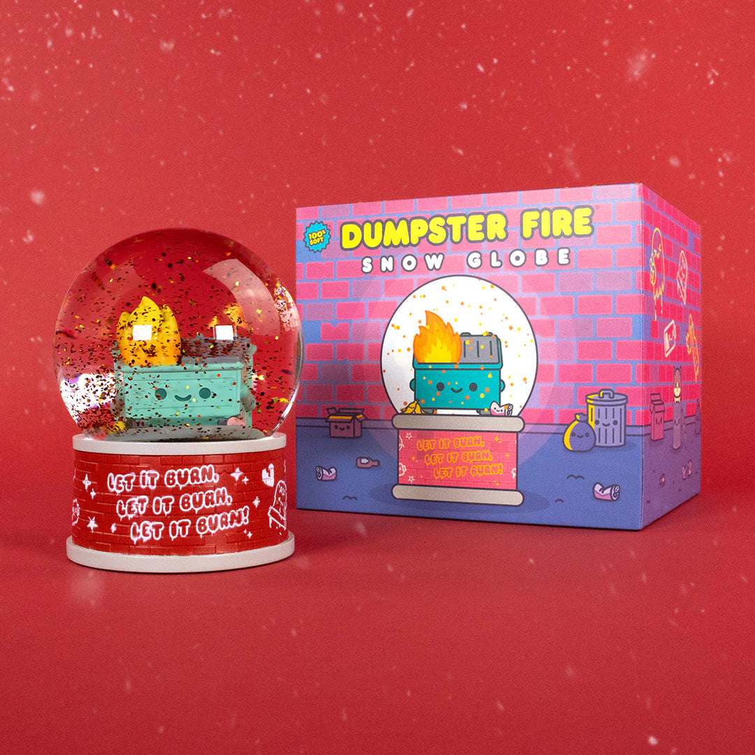 The 100% Soft Dumpster Fire Snow Globe features a smiling dumpster in flames with glitter, and a base that says “Let it burn. Let it burn. Let it burn!” Comes boxed with a colorful holiday design on a red, snowflake background.