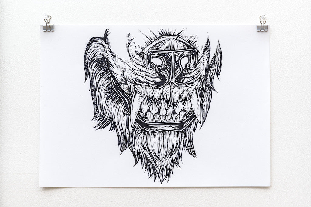 A symmetrical black and white ink drawing by Rhys Cooper features a fierce animal face with sharp teeth and a mane. Its a preliminary sketch mounted on a white background with two clips.