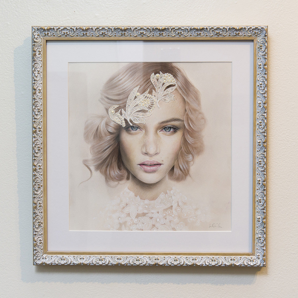A Bec Winnel framed portrait features a woman with light brown hair, wearing a lace-like forehead mask. The ornate frame complements the pastel artwork, capturing her gentle expression with ethereal quality through delicate hues and intricate detailing.