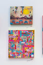 Two abstract paintings adorn a white wall. The top piece, part of the Supersonic Invitational by Haunted Euth, showcases geometric shapes resembling a landscape with circles and lines. Below it is a vibrant collage featuring mixed patterns and colorful elements, including a partial ANATA label.