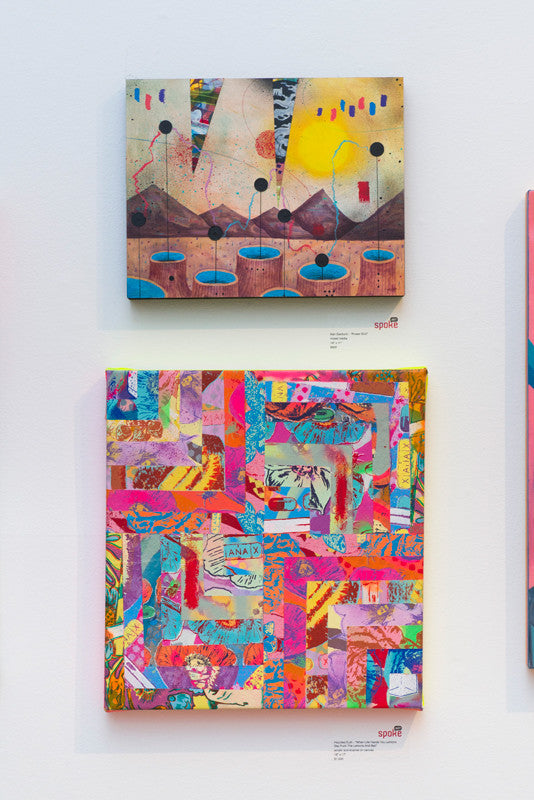 Two abstract paintings adorn a white wall. The top piece, part of the Supersonic Invitational by Haunted Euth, showcases geometric shapes resembling a landscape with circles and lines. Below it is a vibrant collage featuring mixed patterns and colorful elements, including a partial ANATA label.